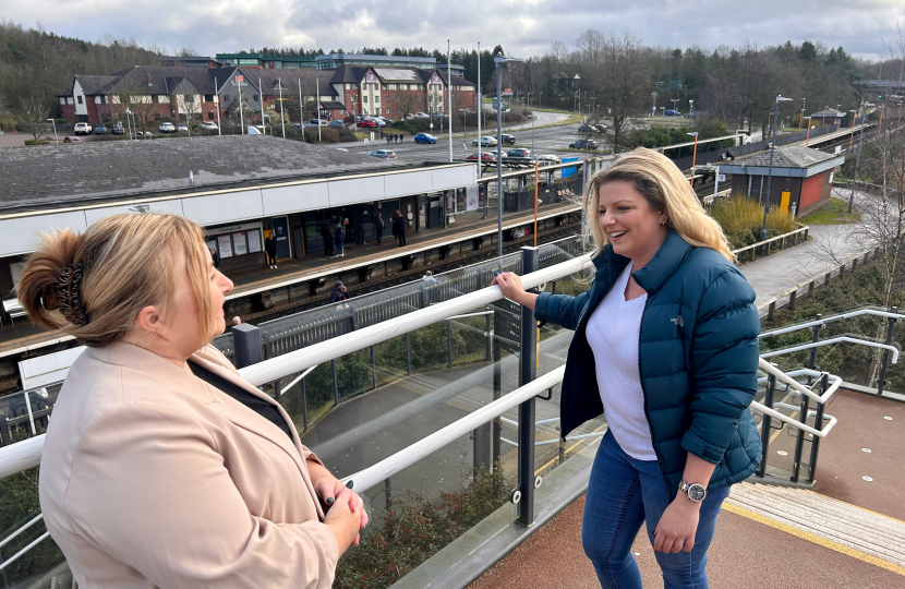 Hannah discusses with a Councillor how to improve rail links to Birmingham at the train station