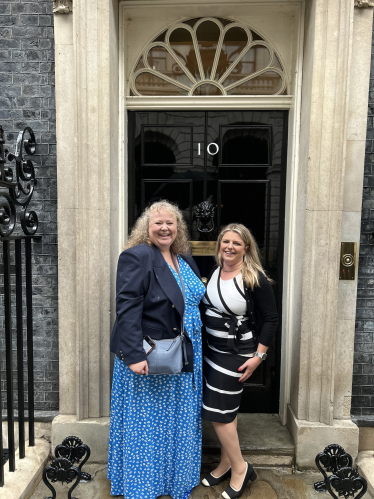 Hannah and Samantha outside of the number 10 front door.